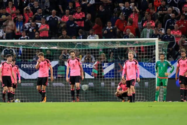Scotland's players look dejected as a 2-2 draw in Ljubljana saw them fall short of making the 2018 World Cup play-offs. Picture: PA
