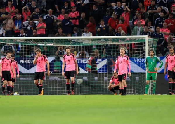 Scotland's players look dejected as a 2-2 draw in Ljubljana saw them fall short of making the 2018 World Cup play-offs. Picture: PA