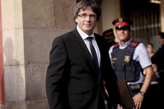 Catalan regional government president Carles Puigdemont arrives to address the Catalan regional parliament in Barcelona.