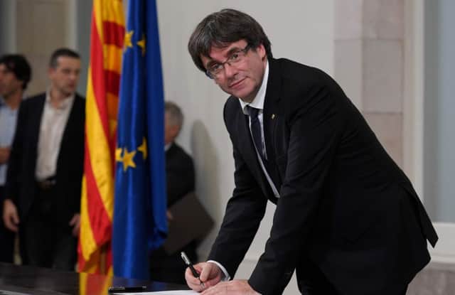 Catalan regional government president Carles Puigdemont signs a document about  the independence of Catalonia at the Catalan regional parliament. Picture; Getty
