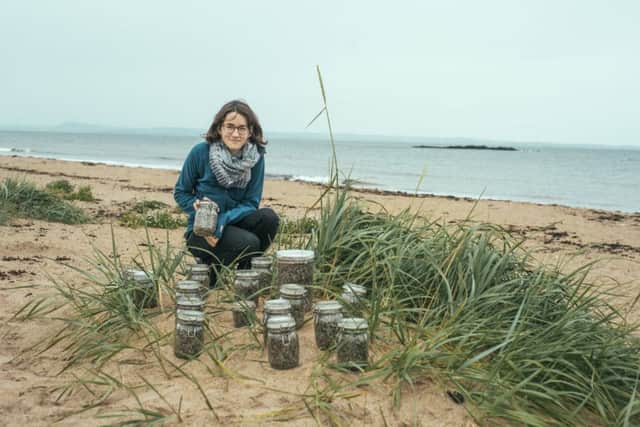 Madeleine Berg of Fidra, with jars of nurdles collected at the nature reserve. Photograph: 
Bryce Powrie