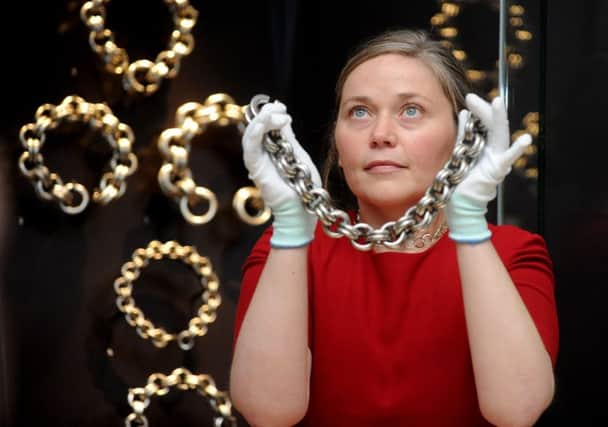 Alice Blackwell of the National Museum of Scotland with some of the surviving silver chains on show together for the first time. Picture: Lisa Ferguson