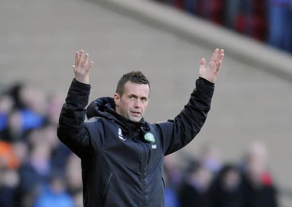A fully clothed Ronny Deila reacts during a match between Celtic and Rangers at Hampden. Picture: John Devlin