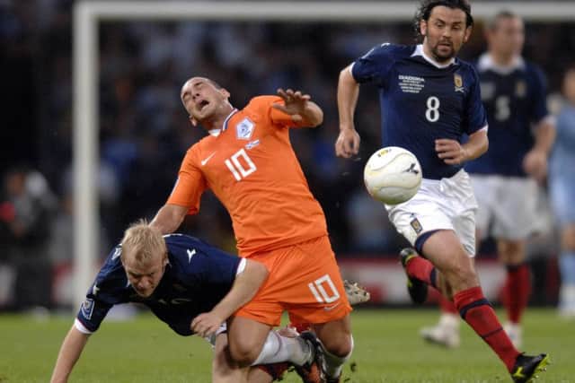 Paul Hartley takes advantage as Wesley Sneijder and Steven Naismith tangle at Hampden in 2009. Picture: Ian Rutherford
