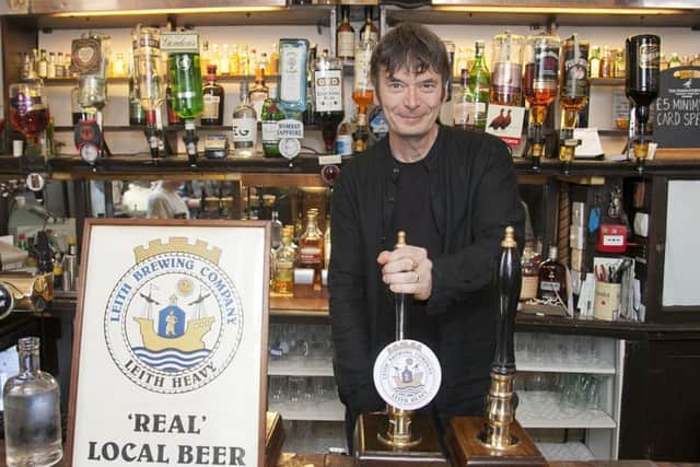 Ian Rankin pulling the first pint of Leith Heavy at the Oxford Bar. Picture: TSPL