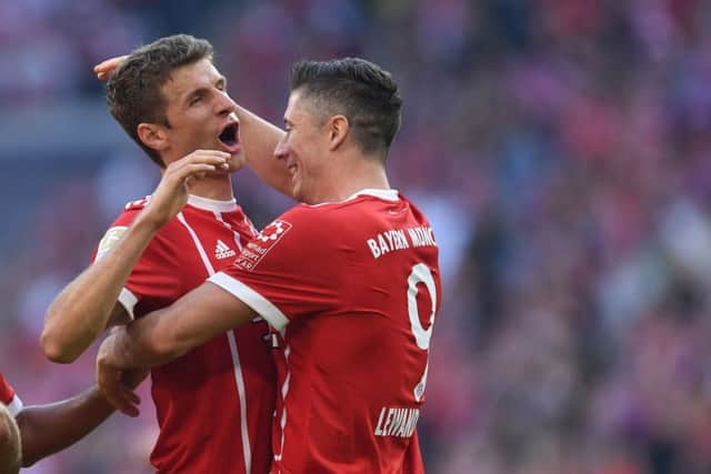 Thomas Mueller and Robert Lewandowski celebrate the Polish strikers goal. Picture: AFP/Getty