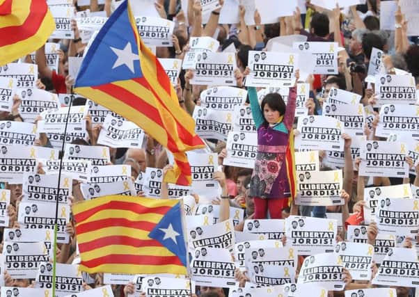 Protesters hold up signs to demand the release of imprisoned Catalan leaders Jordi Sanchez and Jordi Cuixart at a demonstration for Catalan independence  in Barcelona, Spain.  (Photo by Sean Gallup/Getty Images)