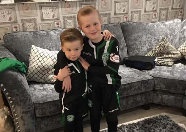 Luke Robertson, whose experimental treatment in Mexico has already extended his life span, with his young brother, Lewis.
