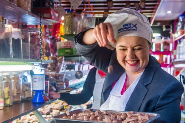 Davidson serves in a sweet shop while campaigning. Picture: Ian Georgeson