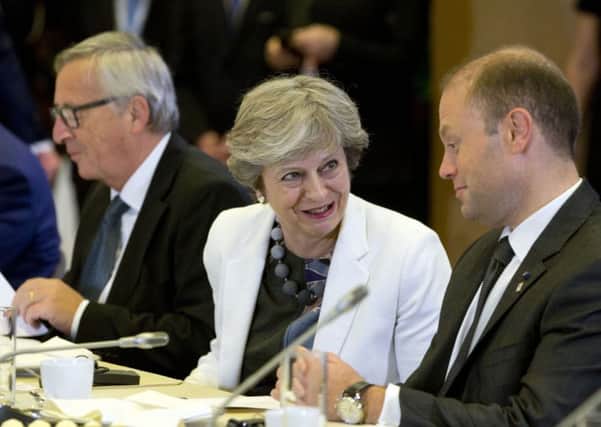 British Prime Minister Theresa May speaks with Malta's Prime Minister Joseph Muscat. Picture: AP Photo/Virginia Mayo, Pool