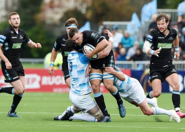 Warriors' Adam Ashe is tackled by Leinster's James Ryn and Johnny Sexton. Picture: SNS