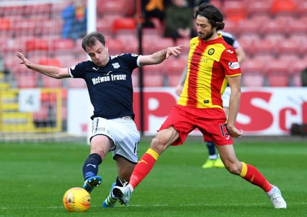 Dundee's Paul McGowan (left) and Adam Barton in action. Picture: SNS/Craig Foy