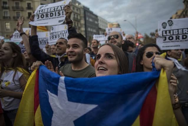 A protester holds an "estelada" or independence flag. (AP Photo/Santi Palacios)