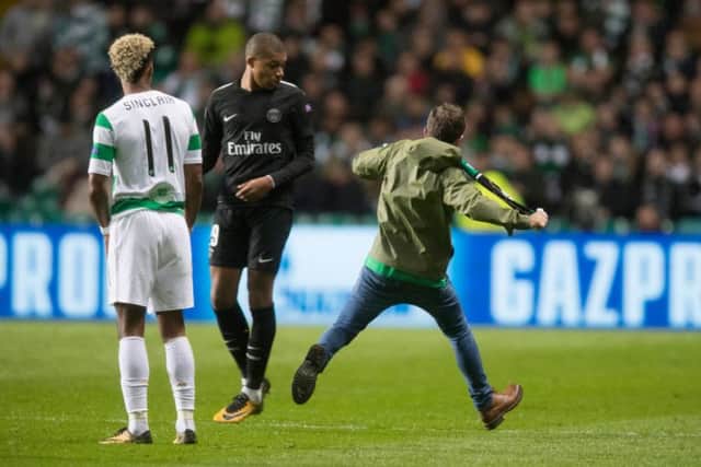 Supporter John Hatton entered the pitch and aimed a kick at PSG star Kylian Mbappe. Picture: Getty