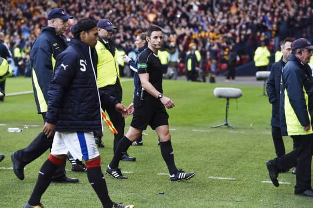 Referee Steven McLean walks off the pitch after Sundays controversial semi-final at Hampden. Picture: SNS.