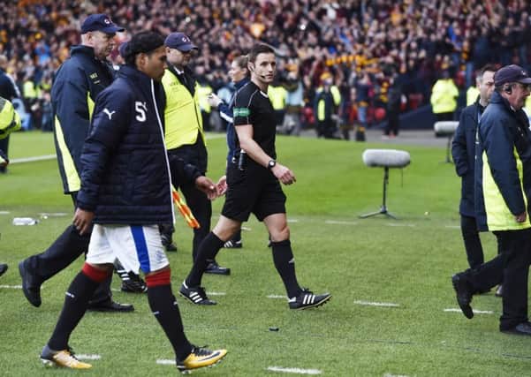 Referee Steven McLean walks off the pitch after Sundays controversial semi-final at Hampden. Picture: SNS.