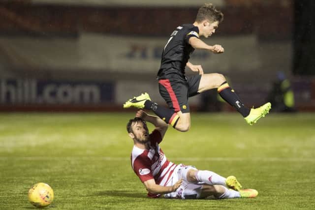 Hamilton's Scott McMann tackles Partick Thistle's Blair Spittal. Picture: Gary Hutchison/SNS