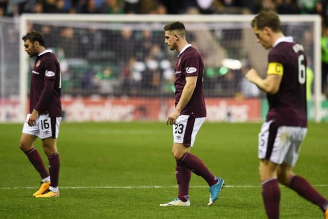 Hearts dejected players trudge off at full time. Picture: SNS