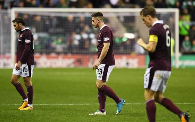 Hearts dejected players trudge off at full time. Picture: SNS