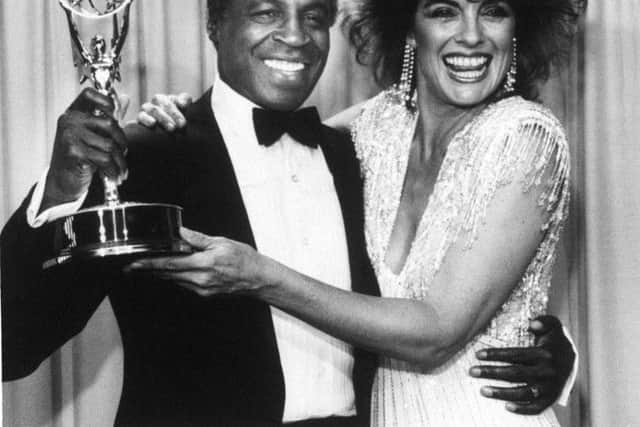Actor Robert Guillaume, star of "Benson", gets a hug from Linda Gray of "Dallas" who presented him with an Emmy in 1985. Picture; AP