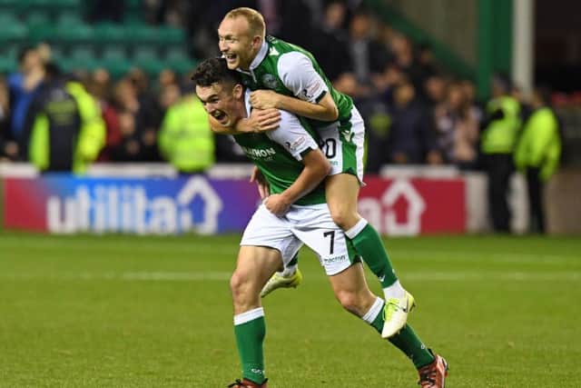 Dylan McGeouch gets a lift from John McGinn during the celebrations at the end of the match. Picture: Ross Parker
