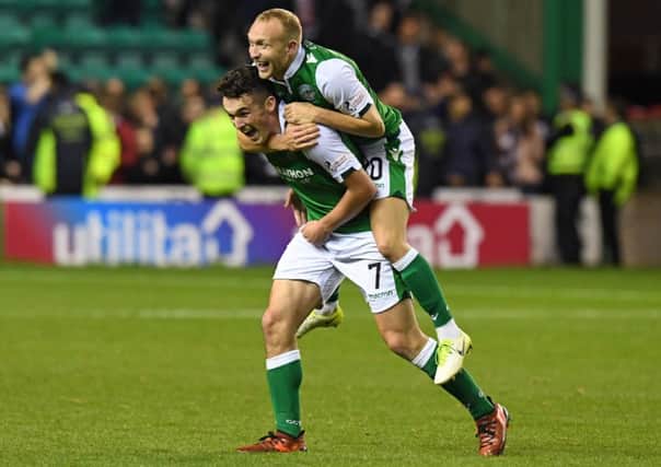 Dylan McGeouch gets a lift from John McGinn during the celebrations at the end of the match. Picture: Ross Parker