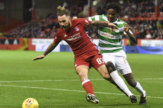 Dedryck Boyata keeps a close eye on Stevie May as Celtic dominated proceedings at Pittodrie. Picture: SNS Group