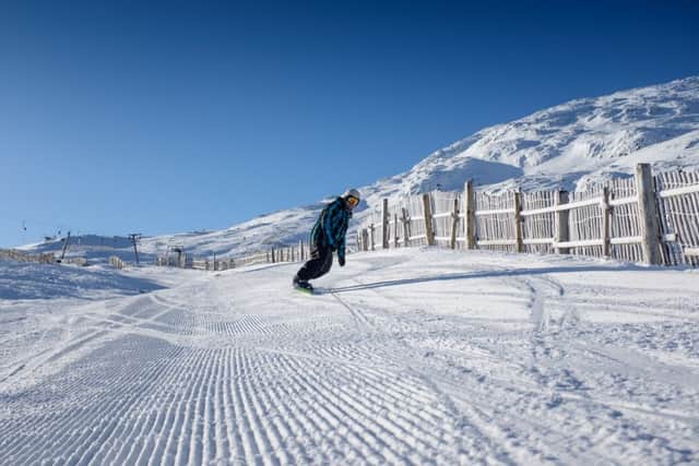 Glencoe Mountain Ski resort is to install snow machines to keep people skiing through the snow drought. A snowboarder is pictured on the Coire Pollach ski run.