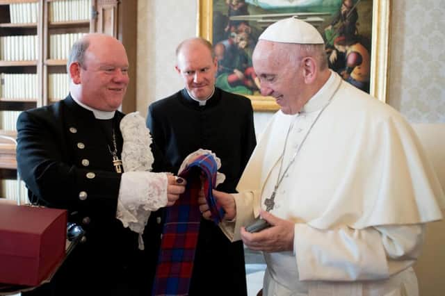 Pope Francis exchanges gifts with Rev. Dr. Derek Browning, Moderator of the Church of Scotland, at the Vatican, Thursday, Oct. 26, 2017. (L'Osservatore Romano/Pool Photo via AP)