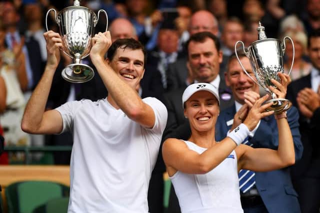 Jamie Murray and Martina Hingis celebrate with their trophies after winning the mixed doubles title at Wimbledon in July. Picture: David Ramos/Getty Images