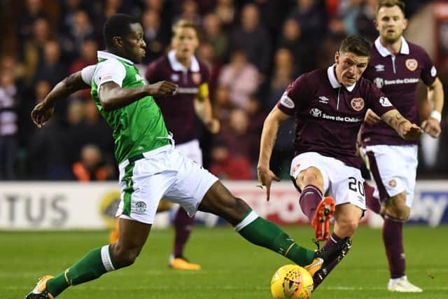 Hibs midfielder Marvin Bartley battles for the ball with Hearts' Ross Callachan. Picture: SNS