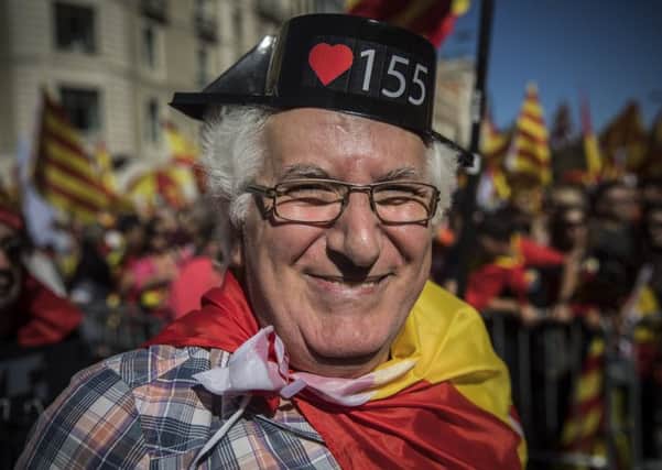 A Barcelona citizen shows his colours at a mass rally yesterday against Catalonias declaration of independence. Picture: AP
