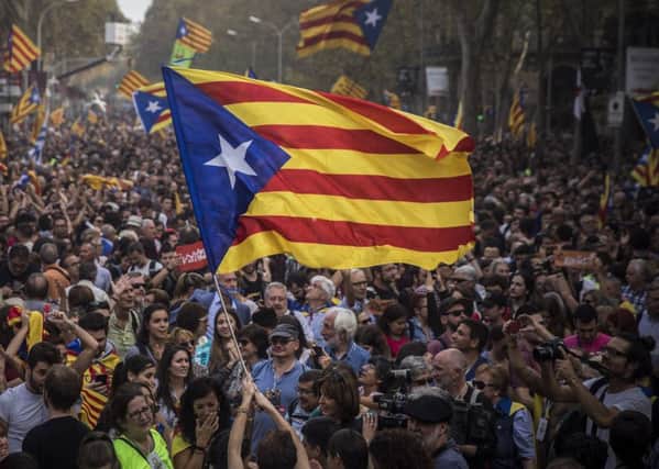 Pro-independence supports celebrate in in Barcelona after Catalonia's parliament voted to declare independence. Picture: Santi Palacios