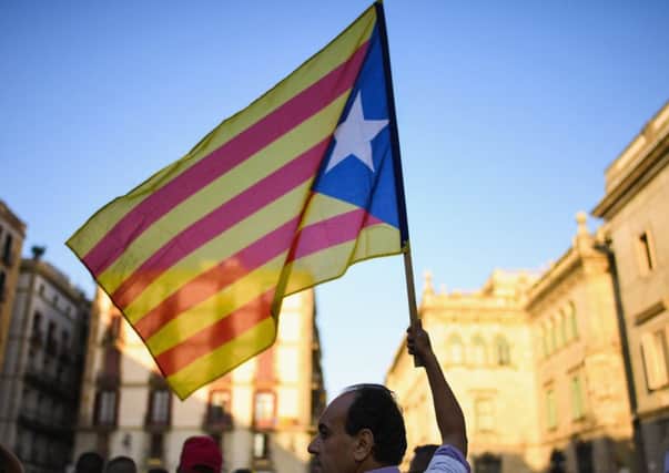An activist holds a Catalan independence flag during a demonstration outside the Palau Catalan Regional Government Building on October 28, 2017 in Barcelona. Picture; Getty