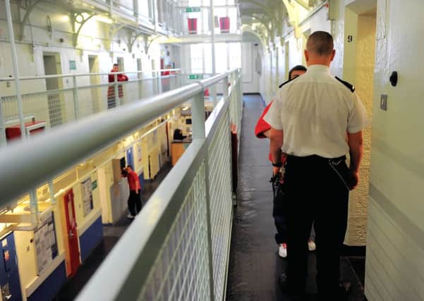 A prison warden talks to an inmate in Barlinnie. Picture: Robert Perry