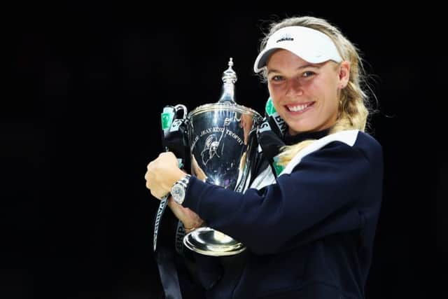 Caroline Wozniacki celebrates with the trophy after defeating Venus Williams in the WTA Finals in Singapore. Picture: Clive Brunskill/Getty
