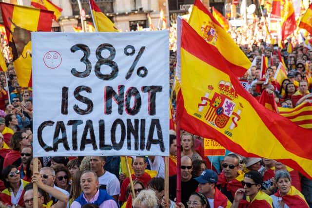 Protesters wave Spanish flags and carry banners during a pro-unity demonstration. Picture: Jack Taylor/Getty Images