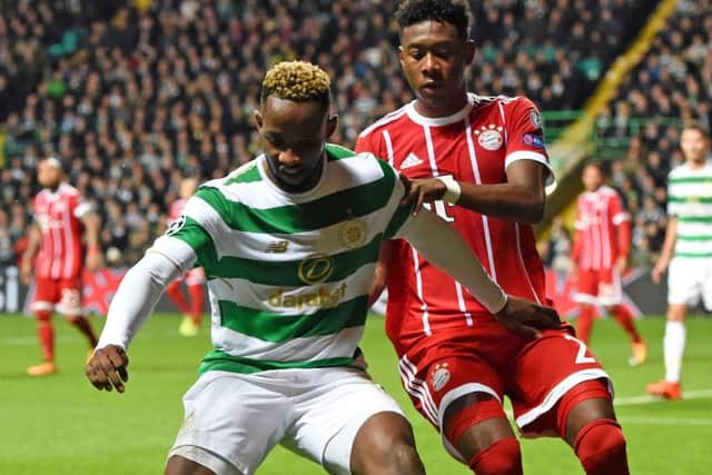 Celtic striker Moussa Dembele holds off Bayern's David Alaba. Picture: SNS