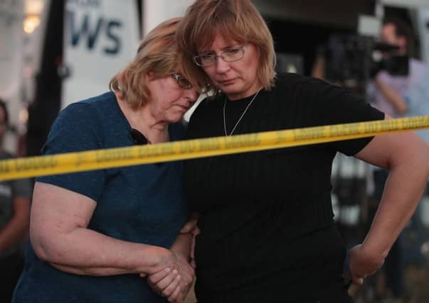 Joan Stanley (left) and her daughter Kellie Hawkins embrace near the First Baptist Church in Sutherland Springs, Texas, following a mass shooting that killed 26 people. Picture: Getty Images