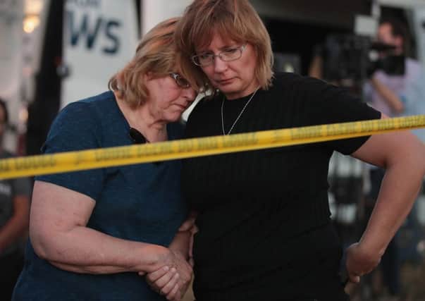 Joan Stanley (left) and her daughter Kellie Hawkins embrace near the First Baptist Church in Sutherland Springs, Texas, following a mass shooting that killed 26 people.  Picture: Getty Images