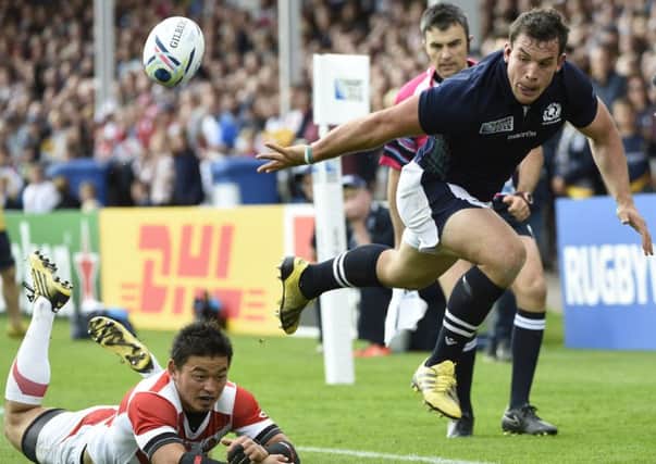 Scotlands John Hardie plays a pass in the build-up to his try in the 45-10 victory over Japan during the 2015 Rugby World Cup. Picture: AFP/Getty