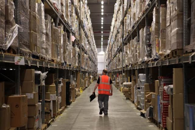 Amazon staff process orders as they prepare their busiest time of the year (Photo by Matt Cardy/Getty Images)