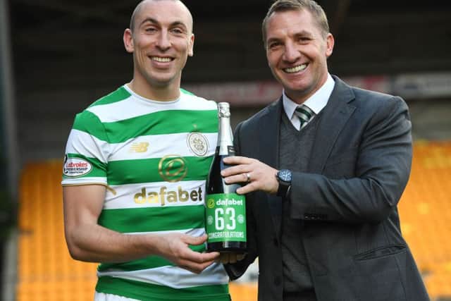 Celtic's Scott Brown and manager Brendan Rodgers celebrate their new unbeaten record. Picture: SNS/Craig Williamson