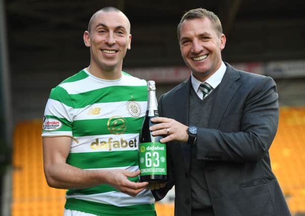 Celtic's Scott Brown and manager Brendan Rodgers celebrate their new unbeaten record. Picture: SNS/Craig Williamson