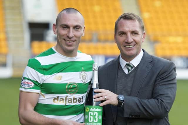 Celtic manager Brendan Rodgers celebrates the club's unbeaten record with Scott Brown. Picture: Craig Foy/SNS