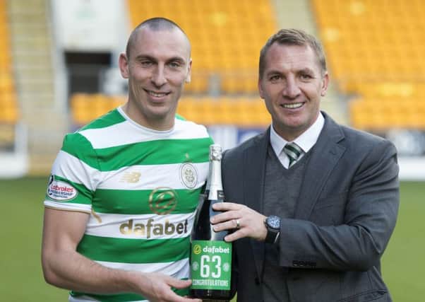 Celtic manager Brendan Rodgers celebrates the club's unbeaten record with Scott Brown. Picture: Craig Foy/SNS