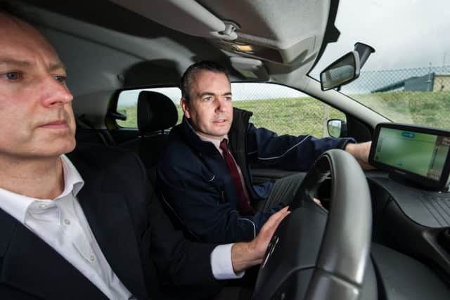 Driver and Vehicle Standards Agency head of driver training  Gordon Witherspoon positions the satnav for Alastair Dalton to follow as part of the new test. Picture: John Devlin