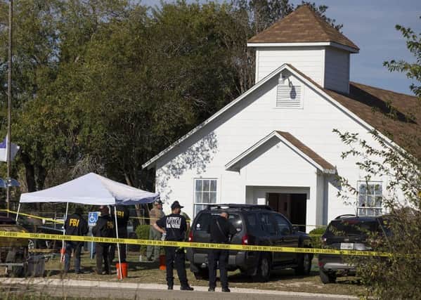 Law enforcement officials works at the scene of a fatal shooting at the First Baptist Church in Sutherland Springs, Texas. Picture: AP