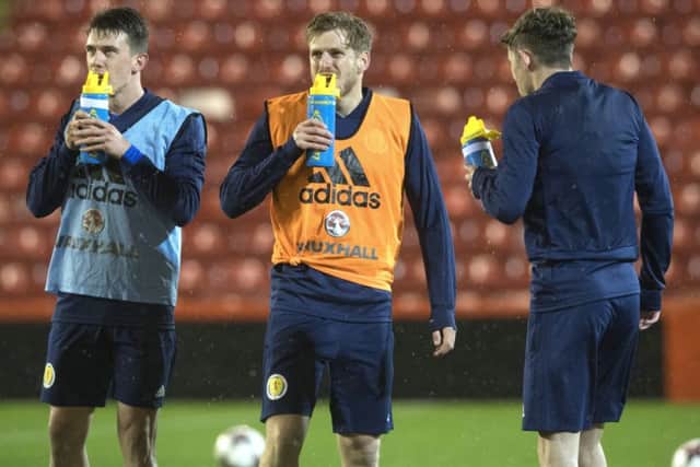 Stuart Armstrong, centre, takes a drinks break in training at Pittodrie . Picture: Craig Foy/SNS