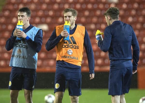 Stuart Armstrong, centre, takes a drinks break in training at Pittodrie . Picture: Craig Foy/SNS